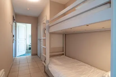 Un ou plusieurs lits dans un hébergement de l'établissement Les Thermes 421- Appt pour 4 avec piscine partagée